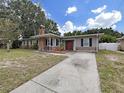 Brick ranch house with driveway at 4004 W Coachman Ave, Tampa, FL 33611