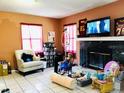 Living room with fireplace, TV, and seating at 1942 Alton Dr, Clearwater, FL 33763