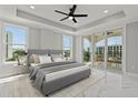 Spacious bedroom with a king-size bed, balcony access, and marble floors at 211 Dolphin Pt # 401, Clearwater, FL 33767