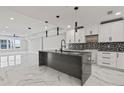 Open-concept kitchen with marble flooring and a large island at 211 Dolphin Pt # 401, Clearwater, FL 33767