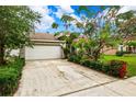 House with a white garage door and driveway at 4931 Ridgemoor Cir, Palm Harbor, FL 34685