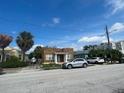 Tan block, Spanish style home with palm trees at 2117 W Cass St, Tampa, FL 33606