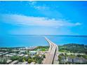 Aerial view showcasing bridge, water, and surrounding landscape at 3087, 3075 Cherry Ln, Clearwater, FL 33759