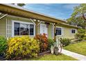 House exterior with landscaping and walkway at 8990 60Th N St, Pinellas Park, FL 33782