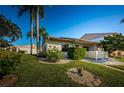 Side view of single story condo with landscaped yard at 180 Ingrid Pl, Oldsmar, FL 34677