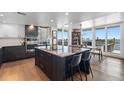 Modern kitchen with dark wood cabinetry, granite island, and stainless steel appliances at 1848 Shore S Dr # 501, South Pasadena, FL 33707