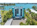 Exterior view of a light teal building with balconies overlooking the water at 1848 Shore S Dr # 501, South Pasadena, FL 33707