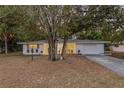 House exterior showcasing curb appeal and tree-lined street at 375 Roosevelt Ave, Brooksville, FL 34604