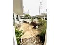 Private patio with white wicker furniture at 1655 S Highland Ave # J194, Clearwater, FL 33756