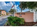 Entrance to Druid Oaks community at 2250 with manicured landscaping at 2250 Druid E Rd # 605, Clearwater, FL 33764