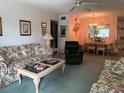 Bright living room with floral sofas and dining area at 2362 Jamaican St # 64, Clearwater, FL 33763