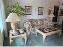 Living room with floral sofa, coffee table, and end tables at 2362 Jamaican St # 64, Clearwater, FL 33763