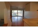 Living room with wood floors and sliding glass doors at 9720 Indian Key Trl # 117, Seminole, FL 33776