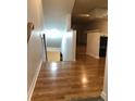 View down a staircase with light wood flooring at 9720 Indian Key Trl # 117, Seminole, FL 33776