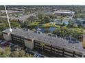 Aerial view of condo building, pool, and surrounding landscape at 14130 Rosemary Ln # 3309, Largo, FL 33774