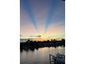Dramatic sunset view over calm water and docked boats at 12405 3Rd E St # 304, Treasure Island, FL 33706