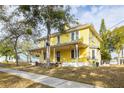 Two-story yellow house with a large front porch, side view at 553 Division St, Tarpon Springs, FL 34689