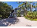 Two-story home with a large driveway and mature landscaping at 761 Soundview Dr, Palm Harbor, FL 34683