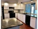 Spacious kitchen with granite countertops and white cabinets at 2101 Sunset Point Rd # 1001, Clearwater, FL 33765