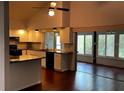 Kitchen with granite counters, white cabinets and view into sunroom at 2101 Sunset Point Rd # 1001, Clearwater, FL 33765