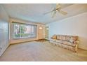 Living area featuring a sofa and access to the front door at 2431 Canadian Way # 9, Clearwater, FL 33763