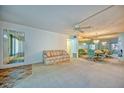 Living room with mirrored walls and dining area at 2431 Canadian Way # 9, Clearwater, FL 33763