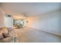 Spacious living room with large windows and a sofa at 2431 Canadian Way # 9, Clearwater, FL 33763