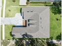 Birds-eye view of the home's roof, landscaping, driveway, and the surrounding green lawn at 4780 Majestic Hills Loop, Brooksville, FL 34601