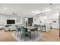 Open concept design with dining area featuring stylish table, chairs, and kitchen with a large center island at 170 98Th N Ave, St Petersburg, FL 33702