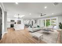Bright open living space featuring modern furnishings, white kitchen, and sliding glass doors to the outdoor area at 170 98Th N Ave, St Petersburg, FL 33702