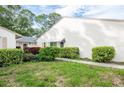 Charming home exterior with well-maintained landscaping, featuring lush greenery and vibrant flowerbeds at 3348 38Th S Way # C, St Petersburg, FL 33711