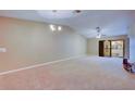 Spacious living room with carpeting and sliding glass doors at 2020 Lakeview Dr # 203, Clearwater, FL 33763