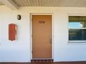Condo building entrance with tan door and address number 308 at 6015 19Th N St # 308, St Petersburg, FL 33714