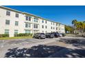 Exterior view of the condo building with parking spaces in front at 2700 Bayshore Blvd # 5109, Dunedin, FL 34698