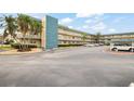 Spacious condominium complex with ample parking and lush landscaping, conveniently located near palm trees at 5750 80Th N St # B208, St Petersburg, FL 33709