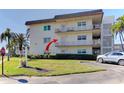 Charming condo exterior with balconies and well-manicured landscaping, plus convenient parking at 5750 80Th N St # B208, St Petersburg, FL 33709