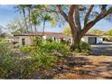 Single story home with a large oak tree and nicely landscaped yard at 570 Casler Ave, Clearwater, FL 33755