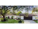 Nice curb appeal, single story home with a large oak tree in the front yard at 570 Casler Ave, Clearwater, FL 33755