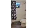 Updated bathroom with white subway tiles, a bathtub, and gray flooring at 1153 Tamarac Dr, Holiday, FL 34690