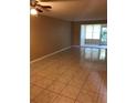 Bright living room with tile floors and access to a screened porch at 4242 Redcliff Pl # 4242, New Port Richey, FL 34652