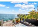 Enjoy waterfront views from this relaxing patio, featuring comfortable seating and lush landscaping at 4974 Coquina Key Se Dr, St Petersburg, FL 33705