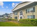 Building entrance with landscaping and brick facade at 1001 Eden Isle Ne Dr # 1, St Petersburg, FL 33704