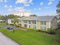 Two-story building with landscaping and a nearby taller building at 1001 Eden Isle Ne Dr # 1, St Petersburg, FL 33704