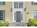 Building's entrance with dark green door and brick exterior at 1001 Eden Isle Ne Dr # 1, St Petersburg, FL 33704