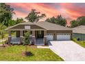 Two-story craftsman style home with a three-car garage and large lot at 6436 Summit View Dr, Brooksville, FL 34601