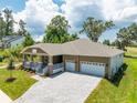 House with a two-car garage and a large driveway at 6436 Summit View Dr, Brooksville, FL 34601