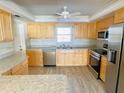 Bright kitchen with stainless steel appliances and light wood cabinets at 5130 Brittany S Dr # 408, St Petersburg, FL 33715