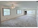 Spacious living room with large windows and ceiling fans at 11200 102Nd Ave # 51, Seminole, FL 33778