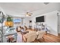 Bright living room with comfy seating, large TV, and hardwood floors at 2960 59Th S St # 310, Gulfport, FL 33707