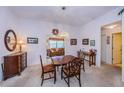 Cozy dining room with carpet, wood table set, and decorative floral accents at 4136 Rhone Dr, New Port Richey, FL 34655